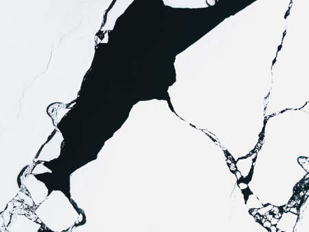Ice with snow on the lake. Aerial drone view. Abstract nature background. Baikal lake, Siberia, Russia.の写真素材