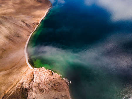 Fog over the coast of lake. Aerial drone view. Clear blue water and cliffs. Baikal lake, Siberia, Russia. beautiful spring landscapeの写真素材