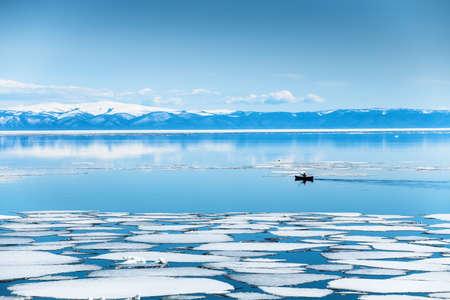 Kayak sailing between ice floes on the lake. Baikal lake, Siberia, Russia. beautiful spring landscape.の写真素材