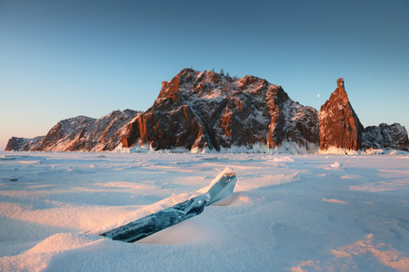 Baikal lake in winter with snow and ice. Sunrise at Khoboy cape of Olkhon island, Baikal, Siberia, Russia. Winter landscapeの写真素材