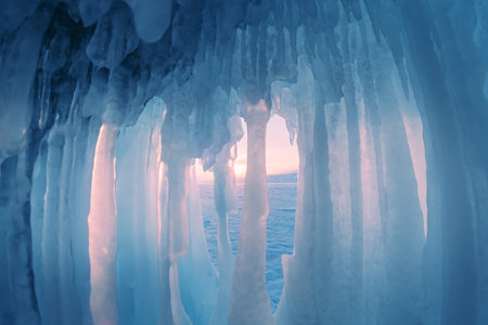 Ice cave with icicles on Baikal lake at sunset. Winter landscape of Baikal lake, Siberia, Russiaの写真素材