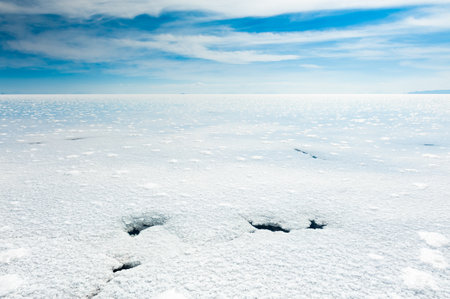 White salt surface with water in Salar de Uyuni salt flat in Bolivia. South America landscapes.の写真素材