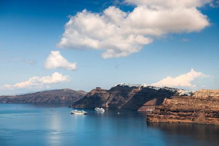 Santorini island, Greece. Blue sea and the blue sky with clouds. Cruise ships near the coast. Summer seascape. Travel and vacation conceptの写真素材