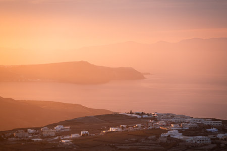 Beautiful pink sunset at Santorini island, Greece. View of the sea and islands. Summer travel and vacationの写真素材