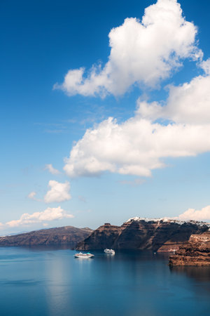 Santorini island, Greece. Blue sea and the blue sky with clouds. Cruise ships near the coast. Summer seascape. Travel and vacation conceptの写真素材