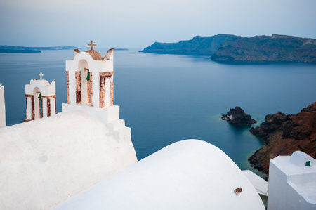 White architecture in Santorini island, Greece. Church in Oia town with sea view.の写真素材