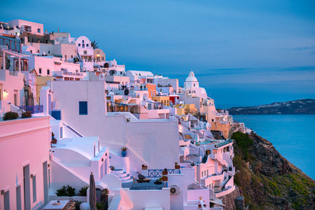 Beautiful sunset at Santorini island, Greece. White architecture in Fira town in pink sunlight. Travel and vacation conceptの写真素材