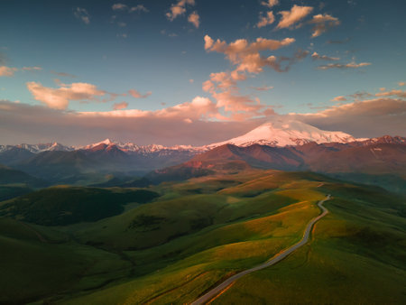 Elbrus mount with pink clouds at sunrise. Gil-Su valley in North Caucasus, Russia. Aerial view. Beautiful summer landscapeの写真素材