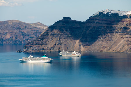 Santorini island, Greece. Cruise ships near the coast. Blue sea and the blue sky. Travel and vacation conceptの写真素材