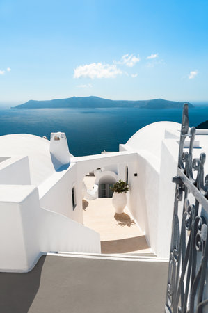 White architecture in Santorini island, Greece. Blue sea and the blue sky with clouds. Travel and summer vacations conceptの写真素材