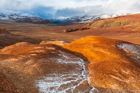 Red colorful mountains in Kyzyl-Chin valley in Altai, Siberia, Russia. First snow in the mountains. Autumn landscapeの写真素材