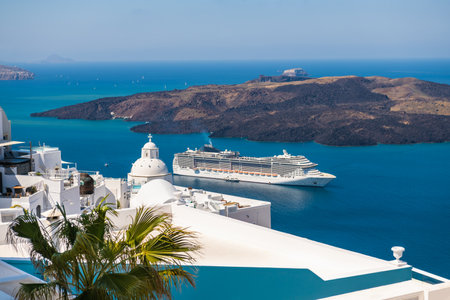 White architecture in Santorini island, Greece. Cruise ship near the coast. Travel and summer vacations conceptの写真素材