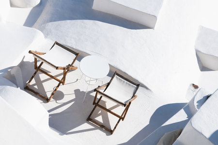 White architecture in Santorini island, Greece. Chaise lounges on the terrace with sea view. Travel and vacation conceptの写真素材