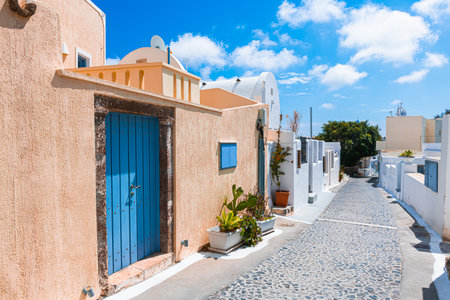 National greek architecture in Megalochori village, Santorini island, Greece. Beautiful street at sunny dayの写真素材