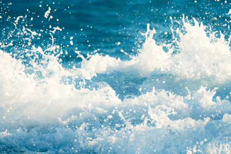 Splash of the sea wave with foam close up. Abstract sea wave background. Waves on the beach in windy day.の写真素材