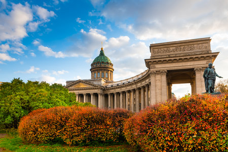 Kazan Cathedral in Saint Petersburg, Russia. Autumn cityscape with red and green trees at sunsetの写真素材