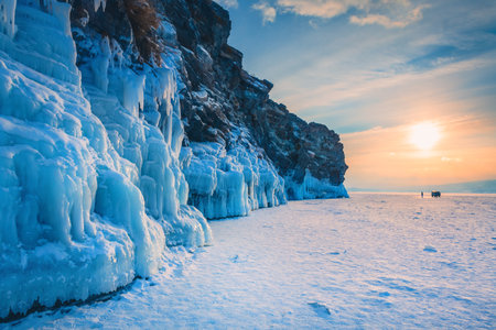 Ogoy island on winter Baikal lake with ice on the rocks. Baikal, Siberia, Russia. Beautiful winter landscape at sunsetの写真素材