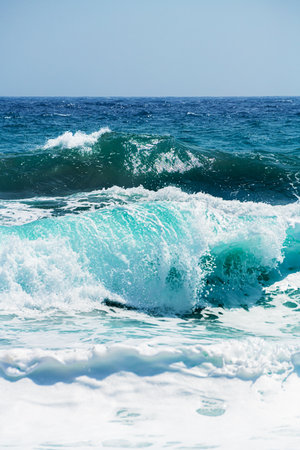 Waves on the beach in windy day. Santorini island, Greece. Blue sea and the blue sky.の写真素材