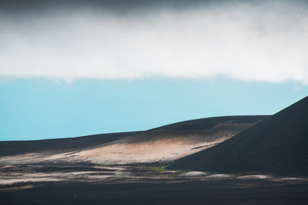 Black lava fields near Tolbachik volcano in Kamchatka peninsula, Russia. Summer landscape at foggy morning.の写真素材