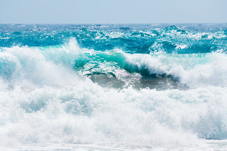 Waves on the beach in windy day. Blue sea and the blue sky. Mediterranean sea, Santorini island, Greece.の写真素材