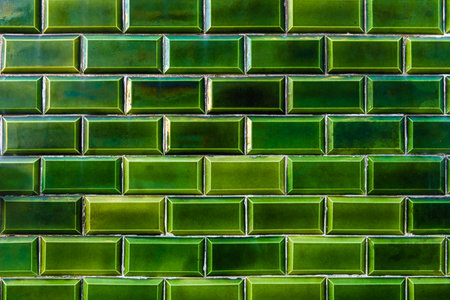 Green glazed tile on the facade of the house close up. Traditional glazed tile in Lisbon, Portugal....