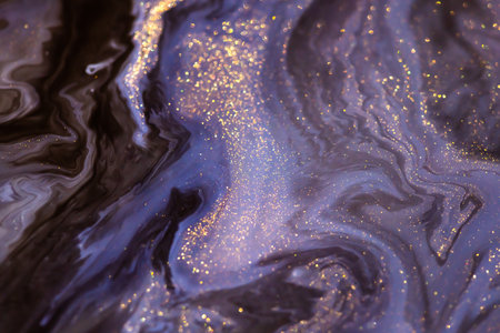 Colorful liquid paint abstract background. Blue, purple and black acrylic paints with shining golden...