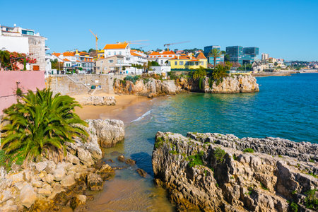 Beautiful beach with rocks in Cascais, Portugal. Coast of Atlantic ocean with blue water at sunny day. Famous travel destinationの写真素材