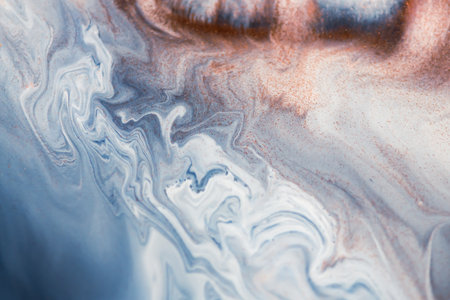 Colorful liquid paint abstract background. Blue and white acrylic paints with golden glitter blending texture. Macro imageの写真素材