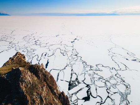 Melting ice on the shore of Baikal lake in spring. Khoboy cape of Olkhon island, Baikal, Siberia, Russia. Aerial view.の写真素材