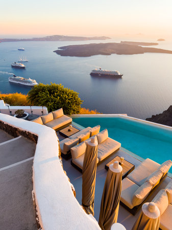 Beautiful sunset at Santorini island, Greece. Luxury swimming pool with sea view. Travel and summer...