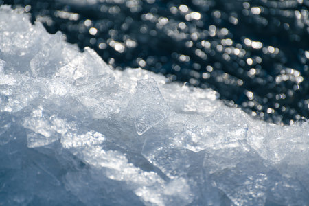 Melting ice floes on the shore of lake in spring. Texture of blue ice close up. Beautiful spring...