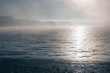 Melting ice on the mountain lake in foggy morning. Beautiful spring landscape. Bannoye lake, Bashkortostan, Russiaの写真素材