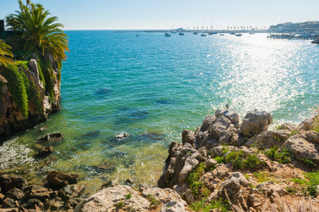 Beautiful beach with rocks in Cascais, Portugal. Coast of Atlantic ocean with blue water at sunny day. Famous travel destinationの写真素材