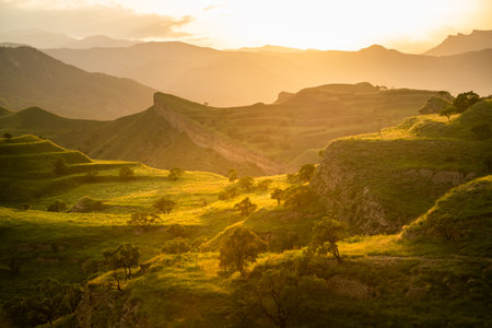 View of the green agricultural terraces in the mountains at sunset. Chokh village in Dagestan, Russia. Beautiful summer landscape.の写真素材