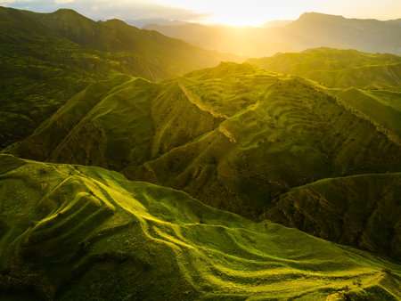 View of the green agricultural terraces in the mountains at sunset. Chokh village in Dagestan,...