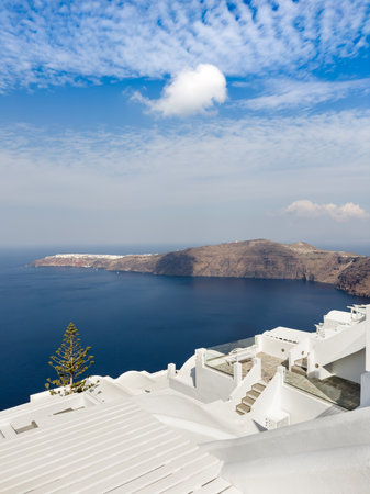 White architecture in Santorini island, Greece. Blue sky with white clouds at sunny day. Sea view. Travel and summer vacationの写真素材