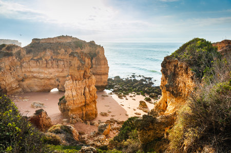 Rocks on the shore of Atlantic ocean in Algarve, Portugal. Beautiful summer seascape at sunrise. Famous travel destinationの写真素材