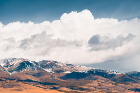 Autumn mountains and blue sky with white clouds at sunny day. Altai mountains, Siberia, Russia. Beautiful autumn landscapeの写真素材