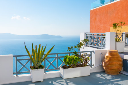 White architecture in Santorini island, Greece. Flowers on the terrace with sea view. Travel and summer vacationの写真素材