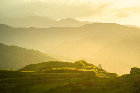 View of the green agricultural terraces in the mountains at sunset. Chokh village in Dagestan, Russia. Beautiful summer landscape.の写真素材