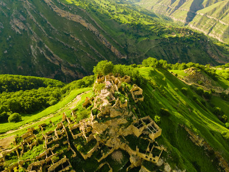Old stone houses in abandoned Gamsutl mountain village in Dagestan, Russia. Aerial view. Summer landscape. Famous travel destinationの写真素材