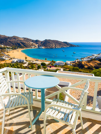 Beautiful terrace with sea view in Ios island, Greece. Two chairs with table on the balcony.. Blue sea and the blue sky at sunny day.の写真素材