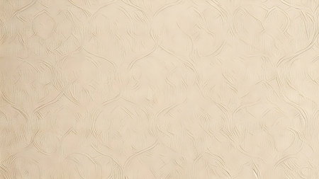 Close-up of a beige textured wallpaper with an intricately repeating pattern. Perfect for backgrounds or home decor.の写真素材