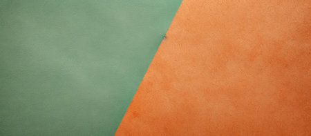 A simple yet striking image featuring two contrasting colors, orange and green.The interplay of texture and color creates a visually engaging abstract composition.の写真素材