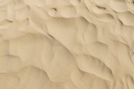 Close-up view of sand dunes, showing the beautiful texture and patterns created by wind and time. A...