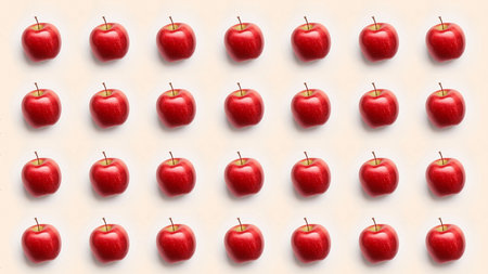 A grid of red apples, creating a simple yet visually appealing pattern. The bright red apples contrast nicely against the soft background.の写真素材