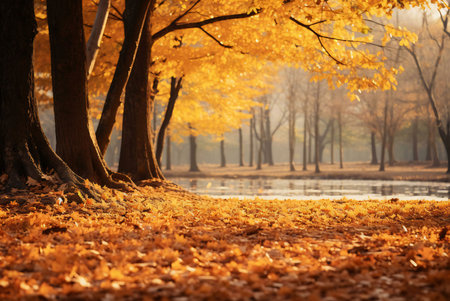 Golden autumn leaves blanket the ground near a calm lake. Trees showcase vibrant fall colors.