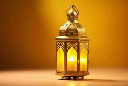 A golden lantern with intricate designs, illuminated by a warm candlelight, creating a serene and festive atmosphere.の写真素材