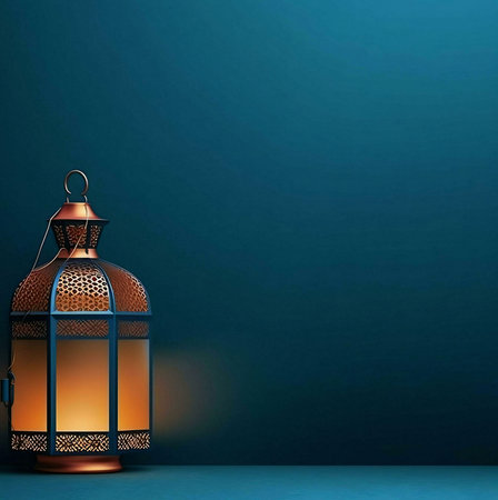 A golden lantern with patterns intricately against a deep blue background. The warm light from the candle casts a glow, creating a peaceful and serene atmosphere.の写真素材