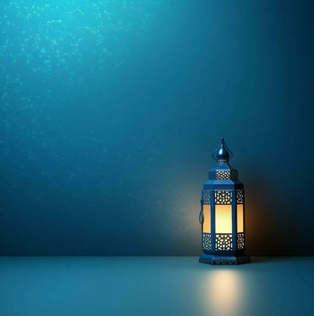 A single, ornate lantern illuminates a teal background with its warm glow, creating a serene and inviting atmosphereの写真素材